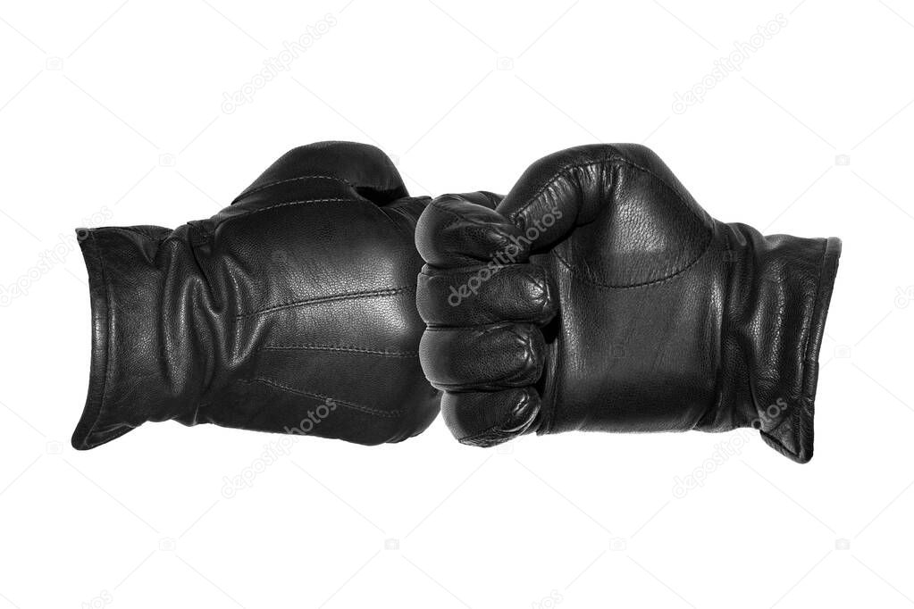 Two leather-gloved hands greet each other with a fist.Greeting each other with a gloved fist during a pandemic.