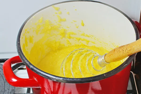 Cozinhar polenta em uma panela velha — Fotografia de Stock