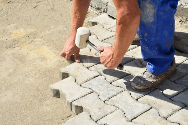 Worker laying interlocking pavers — Stock Photo, Image