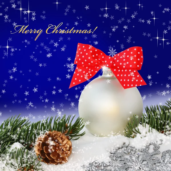 Christmas ball with red bow in the snow — Stock Photo, Image