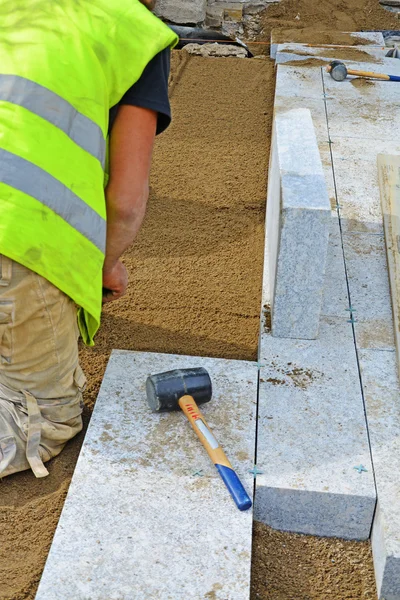 Worker creating screeding sand bedding — Stock Image Worker creating screeding sand bedding Royalty Free Stock Photos