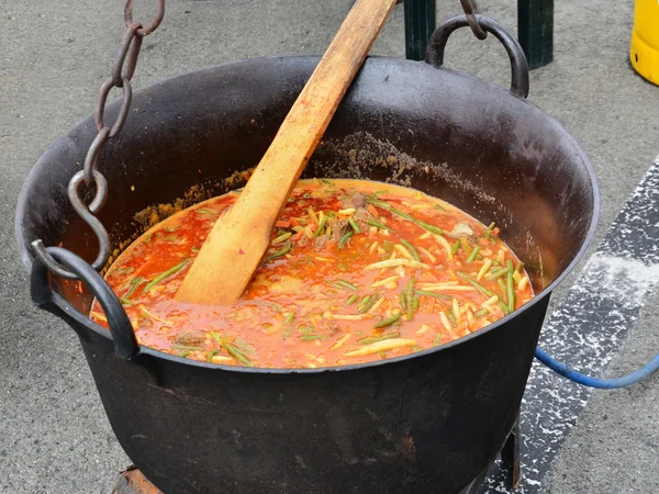 Goulash, stewed meat and vegetables in cauldron — Stock Photo, Image