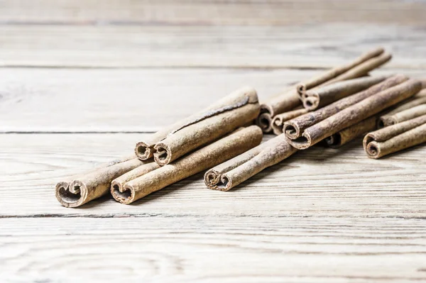 Close-up of cinnamon sticks on a wooden background