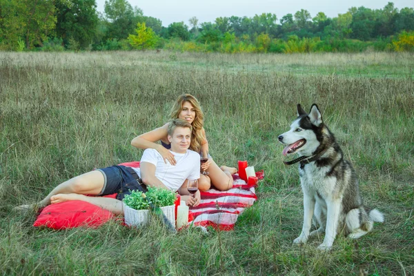 Lovely young beautiful couple resting in park