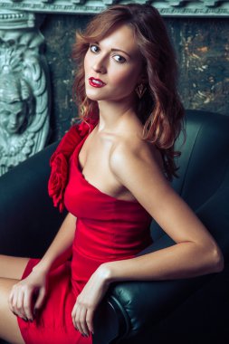 Fashion model posing in red dress.