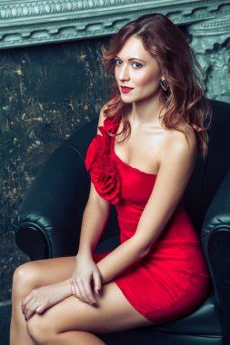 Fashion model posing in red dress.