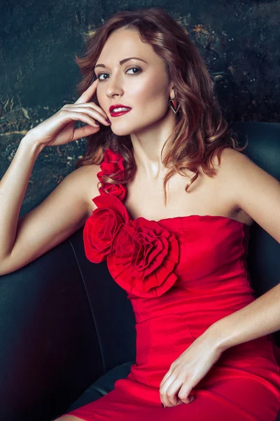 Fashion model posing in red dress. — Stockfoto