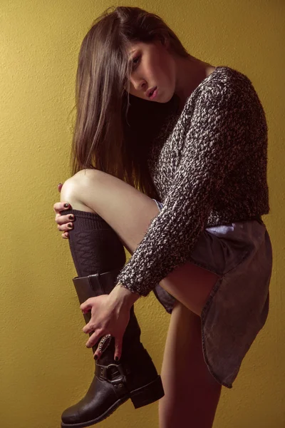 Mixed race sexy fashion model posing on stepladder. — Stockfoto