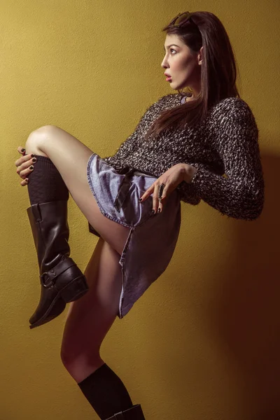 Mixed race sexy fashion model posing on stepladder. — Stok fotoğraf