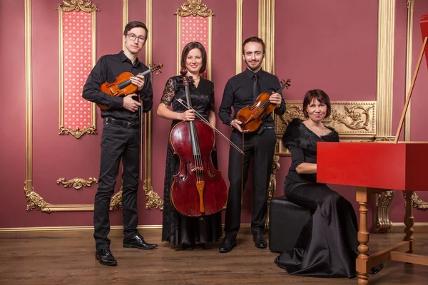 Classical music quartet posing after the concert. — Stock Photo, Image