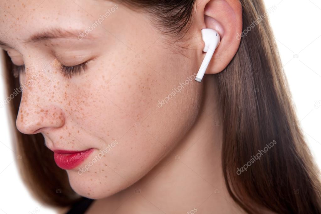 Young woman with wireless earphones