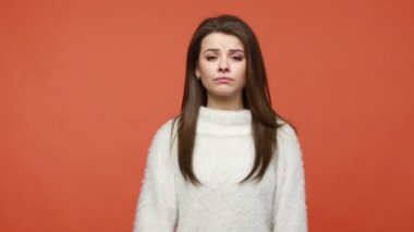 Sen eziksin. Beyaz kazaklı patroniçe, üzgün ve saygısızca seni işaret ederek daha gevşek bir hareket sergiliyor. Turuncu arka planda kapalı stüdyo çekimleri