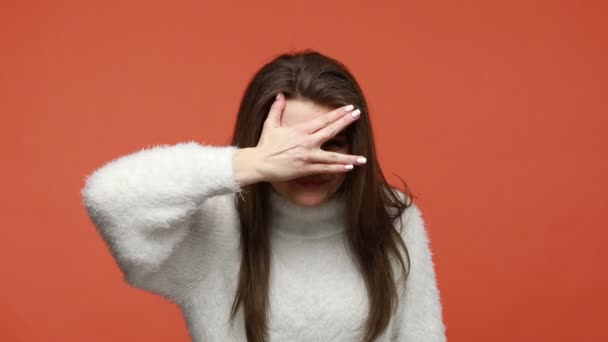 Curious Nosy Brunette Woman White Fluffy Sweater Covering Eyes Palm — Stock Video