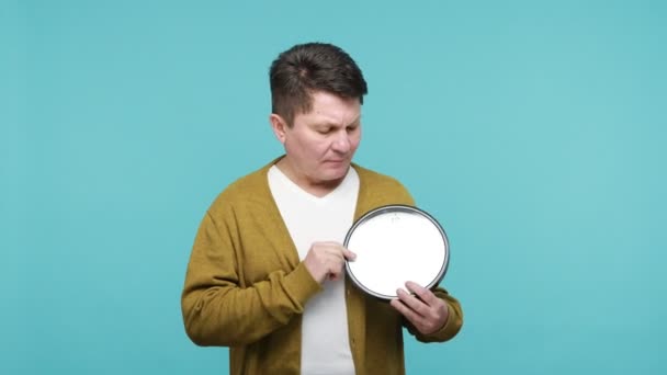 Displeased Impatient Middle Aged Man Biting Nails Looking Wall Clock — Stock Video