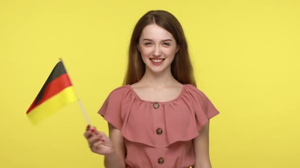 드레스를 국기를 흔들며 웃으며 민주주의의 스튜디오 가노란 배경에 고립된 — 비디오