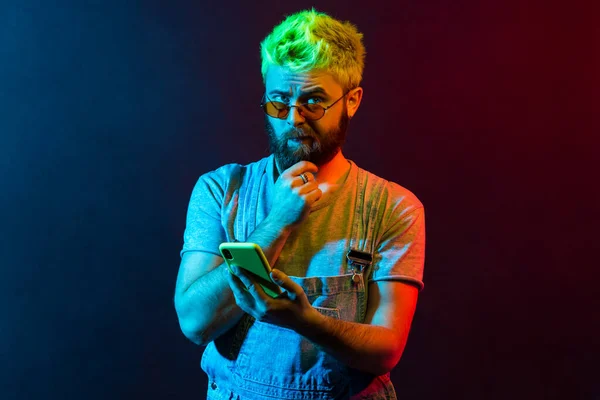Στοχαστικός Γενειοφόρος Άνθρωπος Πράσινα Μαλλιά Ξύσιμο Πηγούνι Κρατώντας Έξυπνο Τηλέφωνο — Φωτογραφία Αρχείου