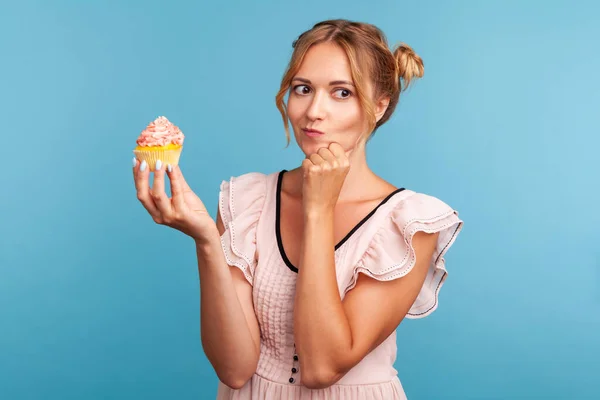 Pensive Young Adult Blonde Female Funny Hair Buns Holding Cake — Stock Photo, Image