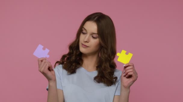 Positive Beautiful Teenager Girl Holding Two Pieces Puzzle Colorful Jigsaw — Stock Video