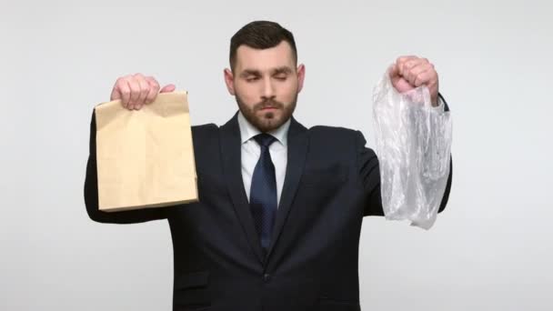 Confused Handsome Bearded Businessman Black Suit Holding Hands Plastic Paper — Stock Video