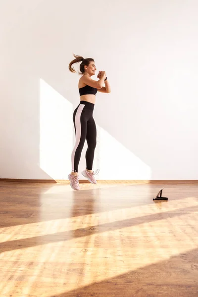 Female Jumping Doing Cardio Exercises Fitness Blogger Watching Tutorial Videos — Stock Photo, Image