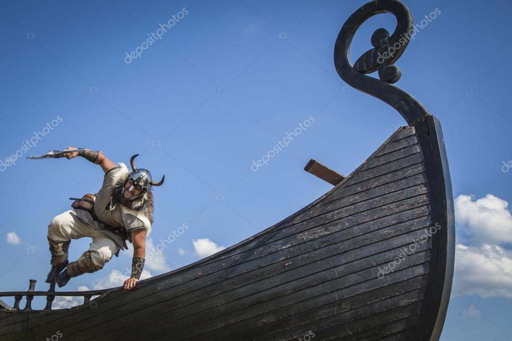 Strong Viking jumping from his ship to attack Stock Photo by ©khosrork 78898994