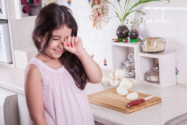 Beautiful small middle eastern girl crying in kitchen, tears of onion. — Stock Photo, Image