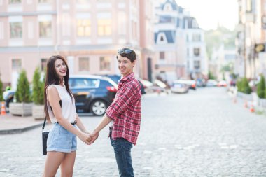 Happy young couple laughing in the city. Love Story series.