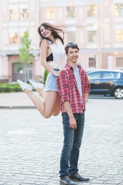Happy young couple laughing in the city. Love Story series.
