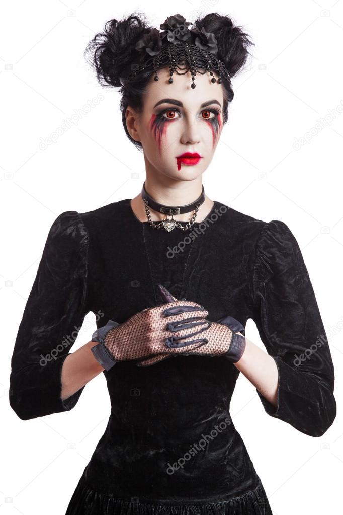 Young beautiful gothic woman with white skin and red lips. Halloween makeup.