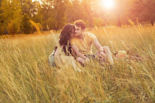 Loving couple lying down on floral field in autumnal park. enjoy, relax and r