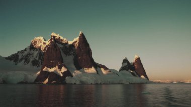 Lemaire strait coastal landscape, mountains and icebergs, Antarctic Peninsula, Antartica. clipart