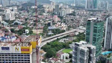 Gündüz boyunca modern yüksek binalar ve daha eski, düşük yoğunluklu yerleşim ve ticari alanların karışımının hakim olduğu büyük, yoğun bir metropol şehrinin zamanaşımı.