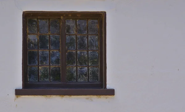 Old abandoned framed windows on plain white walls