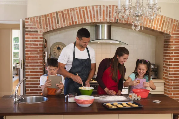 Caucasian Family Baking Kitchen Wearing Aprons Smiling Using Tablet Quality — Stock Photo, Image