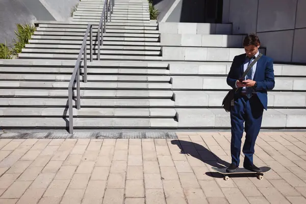 Caucasian Businessman Standing Skateboard Using Smartphone Sun Hanging Out Urban — Stock Photo, Image