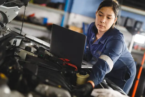 Mixed Race Female Car Mechanic Wearing Overalls Inspecting Car Using — Stock Photo, Image