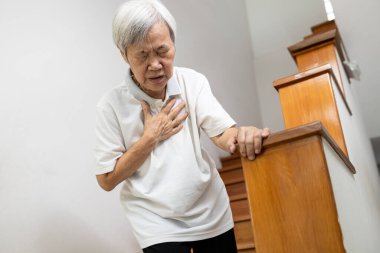 Asian senior grandmother suffering from pain in chest with acute dyspnea or asthma disease,Tired old elderly eyes closed and hand hold her chest,difficulty breathing,shortness of breath,breathless clipart