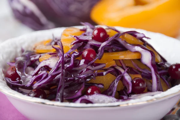 Vitaminic salad of red cabbage, yellow peppers and cranberries.