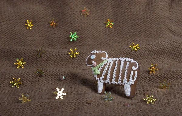 Christmas cookies in the form of a sheep on a knitted woolen kni