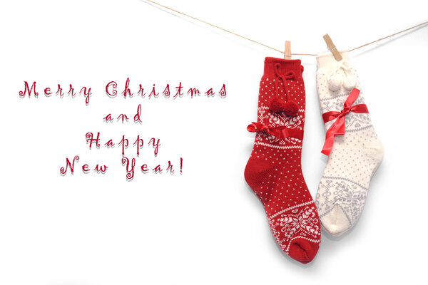 Wool Christmas socks, red and white, on white.