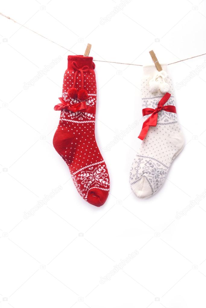 Wool Christmas socks, red and white, on white