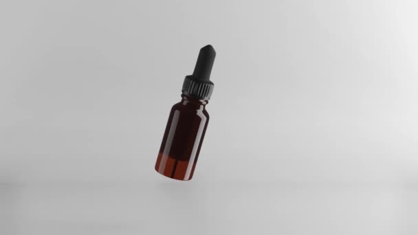 Skleněná hnědá láhev s esenciálními oleji a kapátkem. 3D vykreslení. maketa nahoru — Stock video