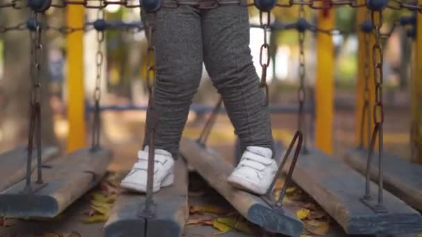 Jambes d'enfant sur une aire de jeux cassée. Danger de blessure pour les enfants — Video