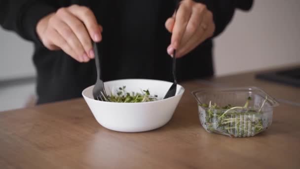 Femeie tânără care pregătește salată din microverdeață ridiche. stil de viață sănătos, superalimente — Videoclip de stoc