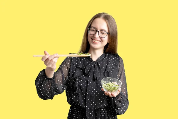 Caucasian young woman with salad isolated on white background. Microgreens superfood — Stock Photo, Image