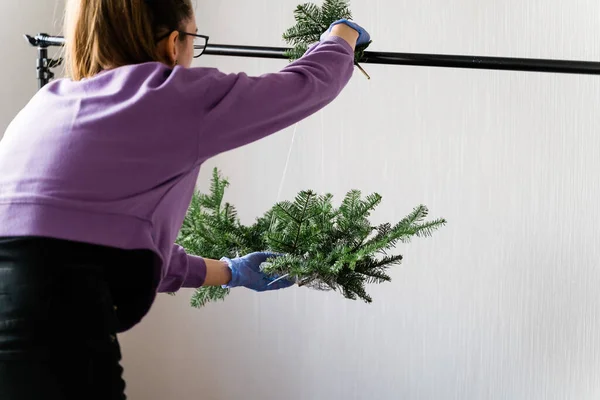 Mujer florista haciendo guirnalda de pino para Navidad en cámara lenta. Decoración de bricolaje, pequeña empresa — Foto de Stock