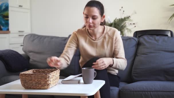 Menina milenar em casa se recusam a usar o telefone e ler um livro. Vício em redes sociais. Perda de tempo. Desligado. Conceito de dependência — Vídeo de Stock