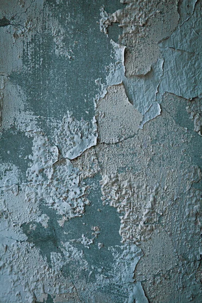 peeling paint from moisture and time on a concrete wall