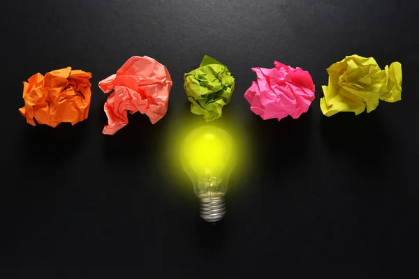 great idea solution concept with crumpled colorful paper and light bulb