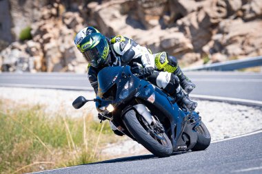 Ağustos 2023 'te İspanya' da virajlı bir dağ yolunda hızlı giden bir motorcu.